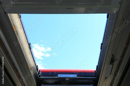 Bus sunroof . Blue sky background