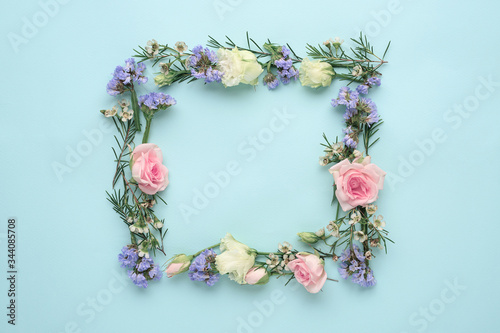 Fototapeta Naklejka Na Ścianę i Meble -  flower frame on blue background, composition of roses, limonium, eustoma, top view, flat lay, copy space
