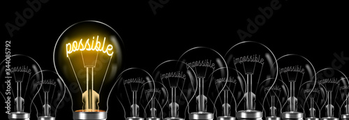 inside the lamps that say impossible, the lamp that says possible shines. impossible to possible concept