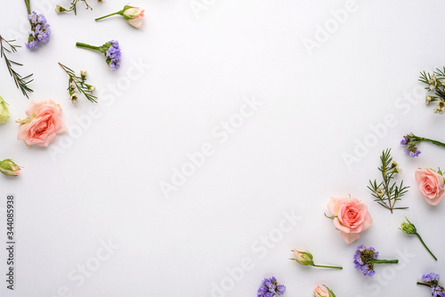 top view flower composition on white background, pink roses, eustoma, limonium in corners, flat lay, copy space photo