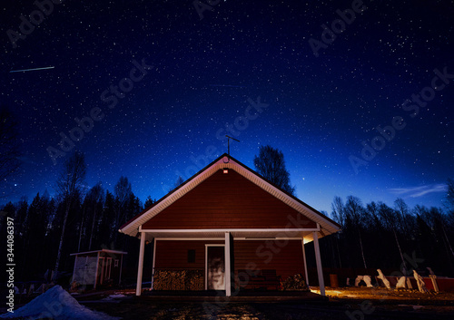 night sky with stars and wooden house