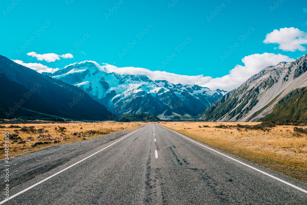 road leading to mountain with snow road leading to mountain with snow