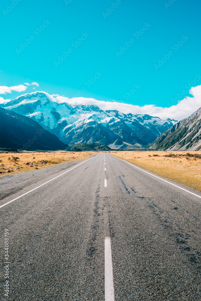 road leading to mountain with snow road leading to mountain with snow
