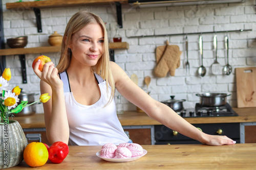 Quadro su tela A woman chose an apple instead of sweets, a concept of a healthy diet