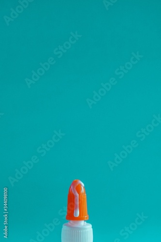 Glue dripping from the nose of its container.