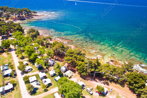 Fototapeta Naklejka Na Ścianę i Meble -  Camping by the sea and crystal clear stone beach aerial view in Savudrija