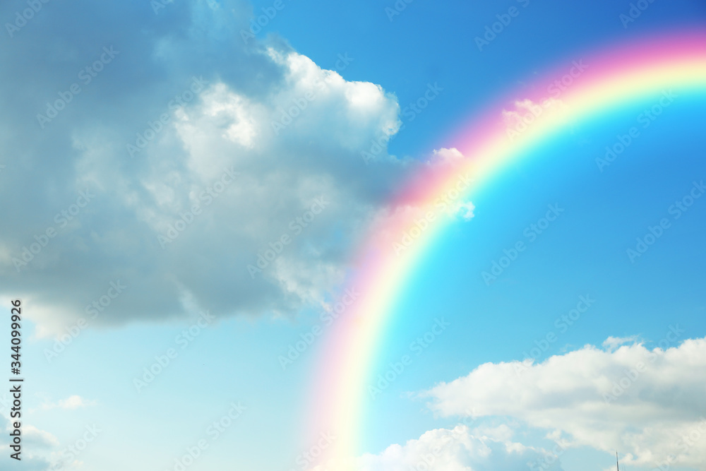 Picturesque view of beautiful rainbow and blue sky on sunny day