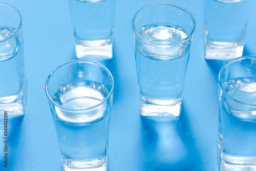 Glasses of clean water on color background Glasses of clean water on color background