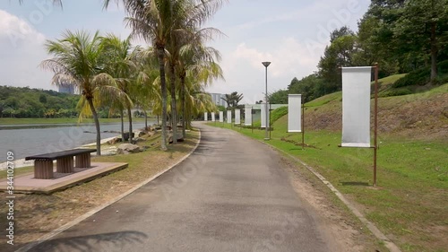 Smooth point of view (POV) footage on a jogging track in a beautiful public park in a sunny day.