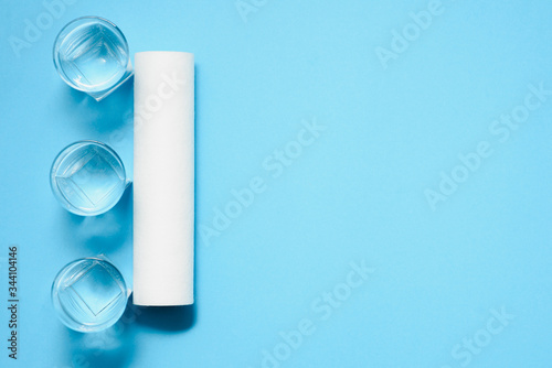 Water filters. Carbon cartridges and glasses on a blue background. Household filtration system.