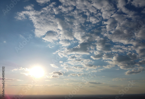 Sky and clouds, sun and horizon at sunset.