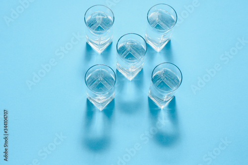 glasses with water on blue background. clean water concept