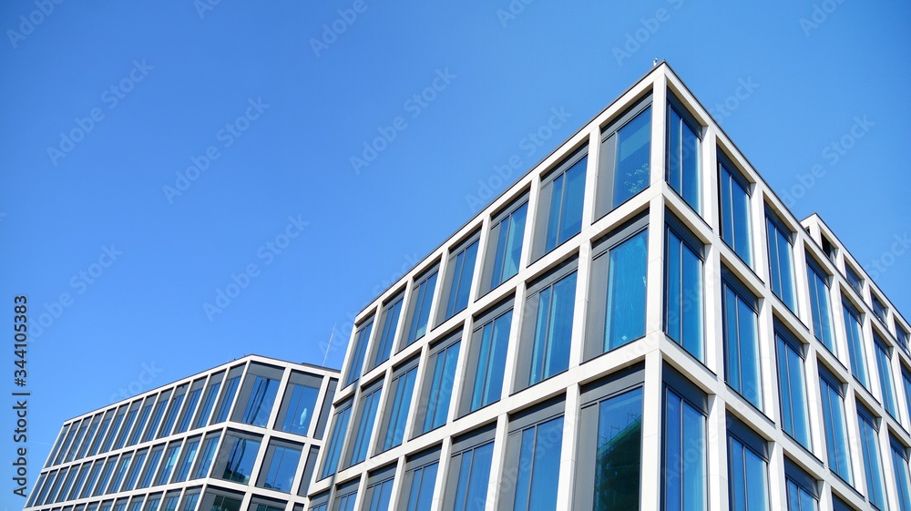 Modern office building windows with vertical lines and reflection. Building reflecting the sky with clouds and creating a surreal view. Modern office building windows with vertical lines and reflection. Building reflecting the sky with clouds and creating a surreal view.