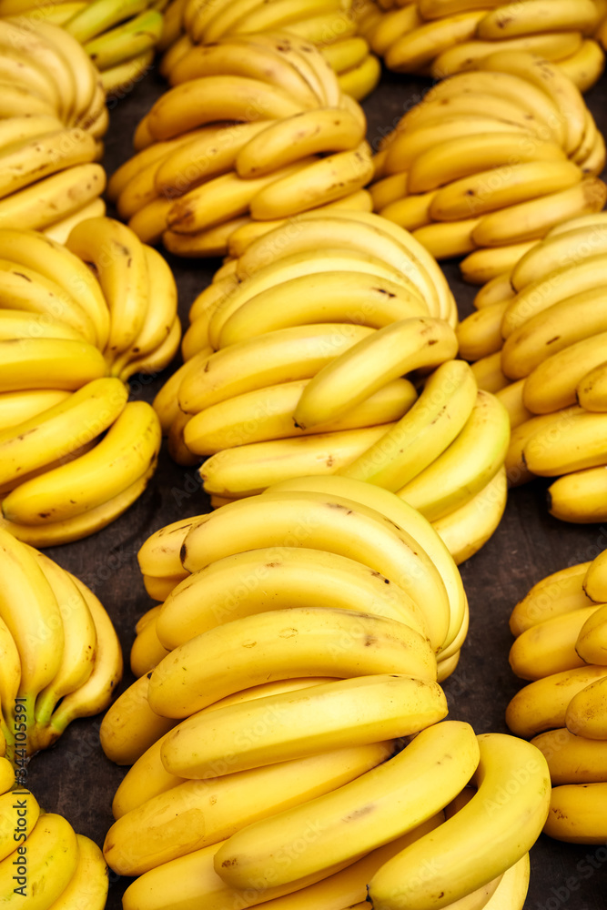 Natural ripe banana bunches on a local market, selective focus.