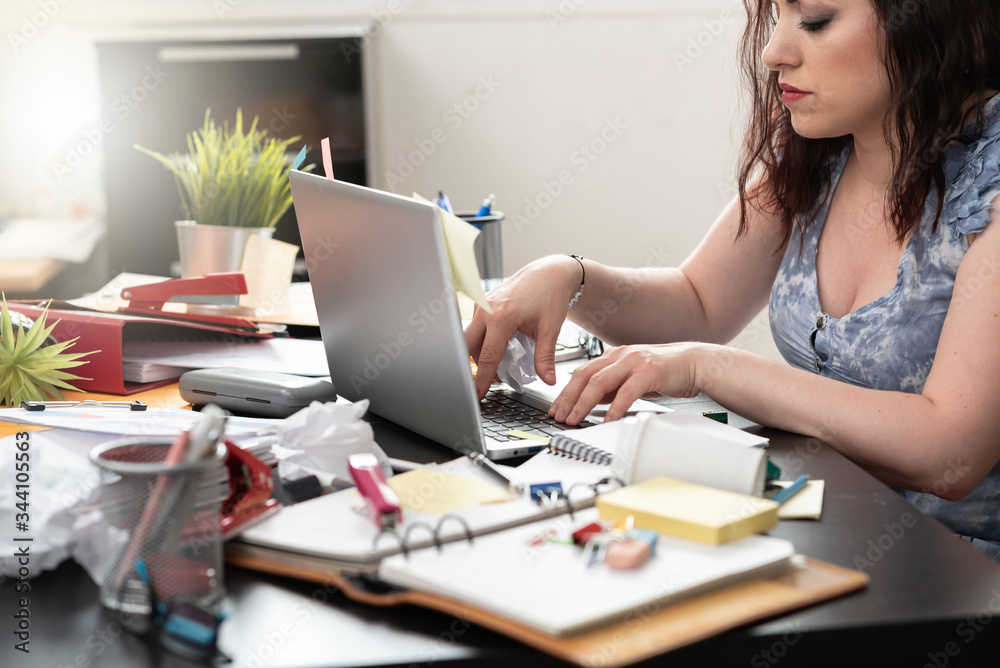 Businesswoman working on a messy desk