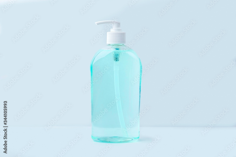 A big bottle with antiseptic sanitizer gel for washing hands on blue background. Alcohol gel as coronavirus prevention. Viral disease prevention concept. Copy space for text A big bottle with antiseptic sanitizer gel for washing hands on blue background. Alcohol gel as coronavirus prevention. Viral disease prevention concept. Copy space for text