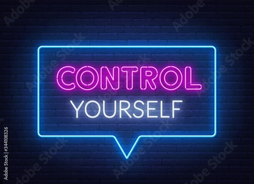 Control Yourself neon lettering on brick wall background.