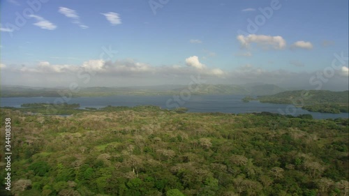 Aerial view of green forests, slopes, lake, Bayano River, the natural reservoir at noon. Shoot with Cineflex systems aerial view
