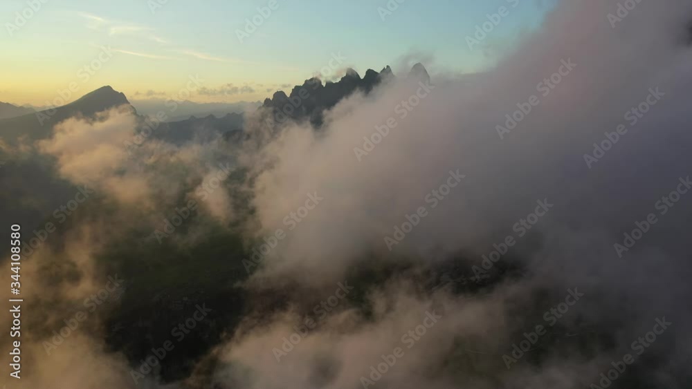 Flight through clouds reveals the Dolomites in Italy at sunset, forward aerial Flight through clouds reveals the Dolomites in Italy at sunset, forward aerial