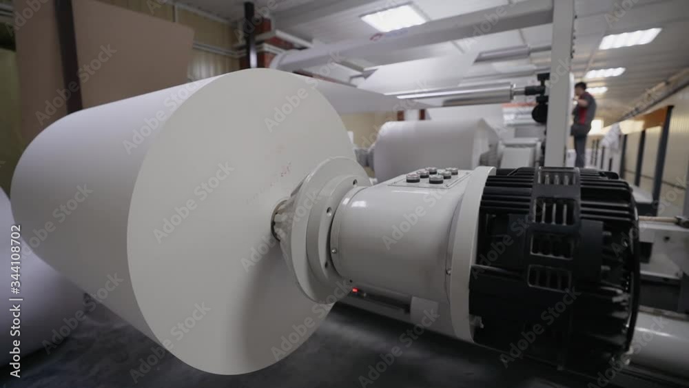 printing house rotating shaft with a roll of white paper