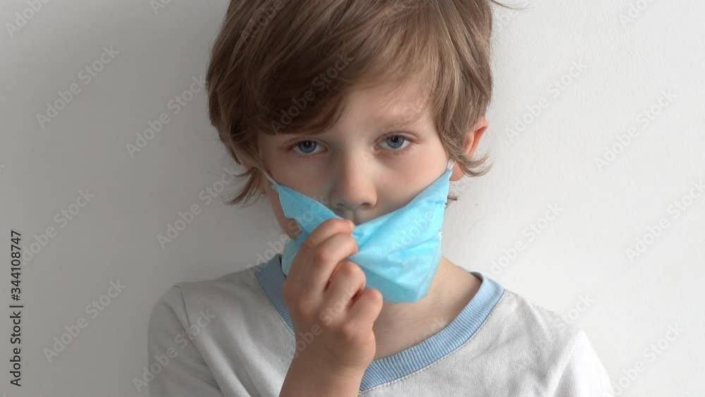 protection against coronavirus. little boy puts a mask on her face. protection against coronavirus. little boy puts a mask on her face.