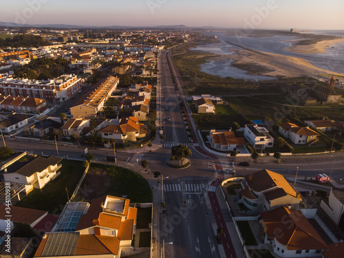 The marginal riverside  along the mouth of the Cavado River at sunset in Esposende  Portugal. The two sides of Restinga de Ofir. One facing the ocean  the other the estuary of C  vado River.