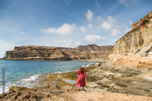 Girl look to forward on ocean and mountains, Gran Canaria, Spain