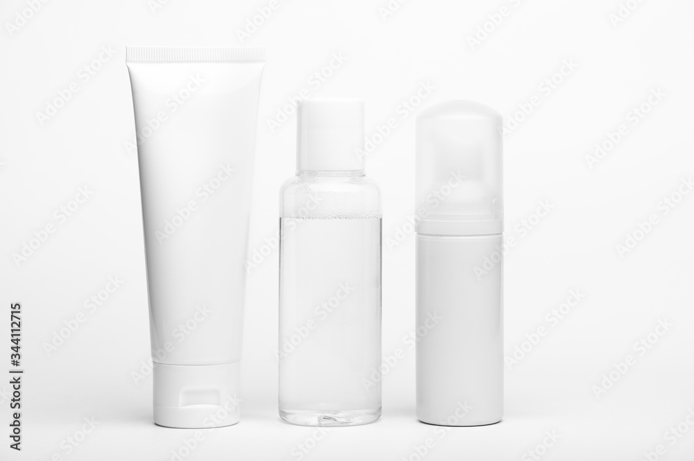 Container for cream, shampoo, toiletry. Unbranded plastic tube and flacons. Bottle with dispenser for cosmetics products. Skincare and beauty concept. Mockup style, copy space. Isolated on white Container for cream, shampoo, toiletry. Unbranded plastic tube and flacons. Bottle with dispenser for cosmetics products. Skincare and beauty concept. Mockup style, copy space. Isolated on white