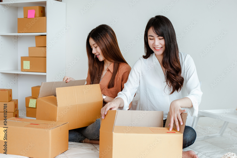 Young woman asian work from home online marketing packaging and delivery for customer at home. Business owner, SME, shipping, work from home(WFH), freelance, Start up concept. Young woman asian work from home online marketing packaging and delivery for customer at home. Business owner, SME, shipping, work from home(WFH), freelance, Start up concept.