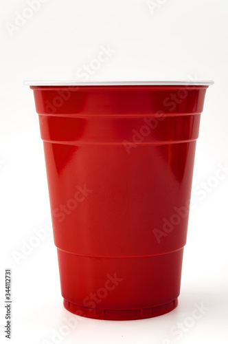 Partying, american drinking games and party supplies concept with red plastic cup isolated on white background with clipping path cutout