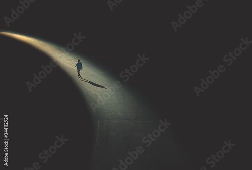 man walking in the night photo