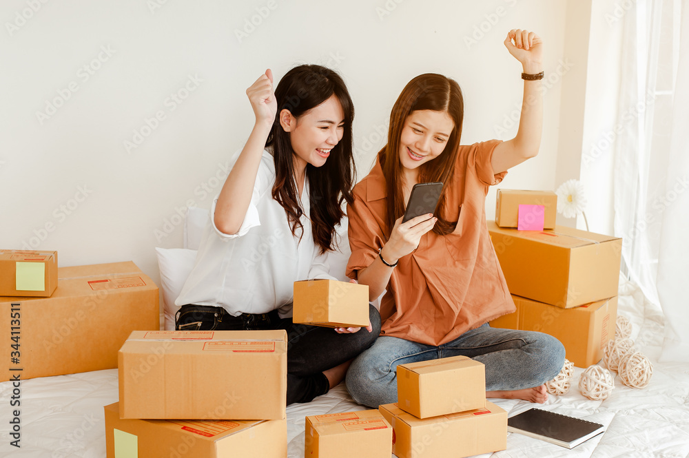 Young woman asian work from home talking with customers to sell products online and delivery for customer. Business owner, SME, shipping, work from home(WFH), freelance, Start up concept. Young woman asian work from home talking with customers to sell products online and delivery for customer. Business owner, SME, shipping, work from home(WFH), freelance, Start up concept.