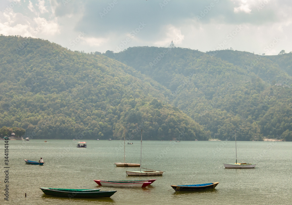 Wooden rowboats idling on the Phewa Lake in the Himalayan city of Pokhara in Nepal.