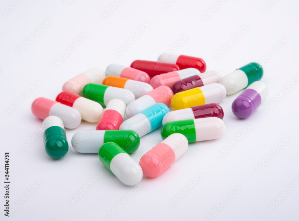 Different color pills on white background Different color pills on white background