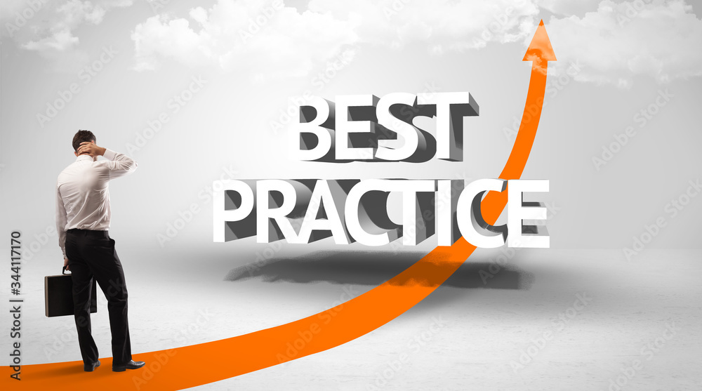 Rear view of a businessman standing in front of BEST PRACTICE inscription, successful business concept Rear view of a businessman standing in front of BEST PRACTICE inscription, successful business concept