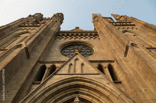 Low angle view of the portico of the main entrance to Jakarta Cathedral, on Java Island, Indonesia, with its characteristic pointed gothic arches and its rose window. photo
