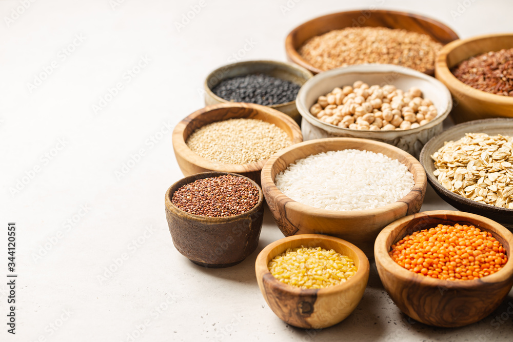 Organic products. Bowls with different gluten free grains on white background