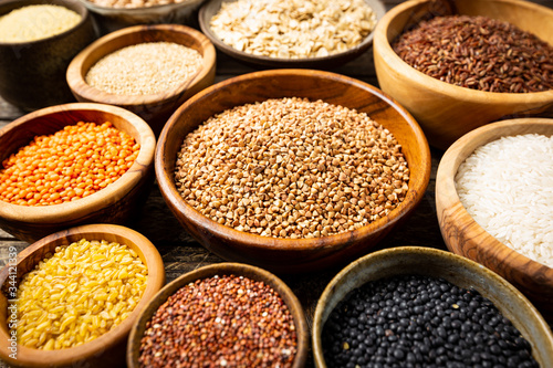 Organic products. Bowls with different gluten free grains on wooden background