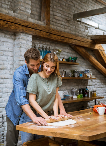 Young couple preparing doug...