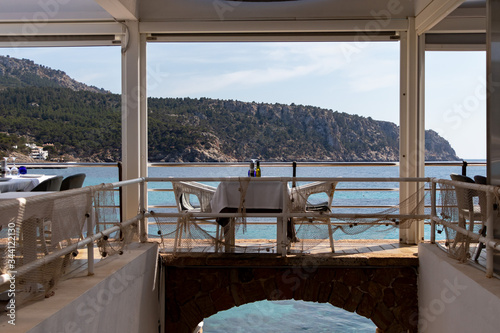 beautiful laid table in a restaurant overlooking the mediterranean sea in sant elm, mallorca, spain © Martin