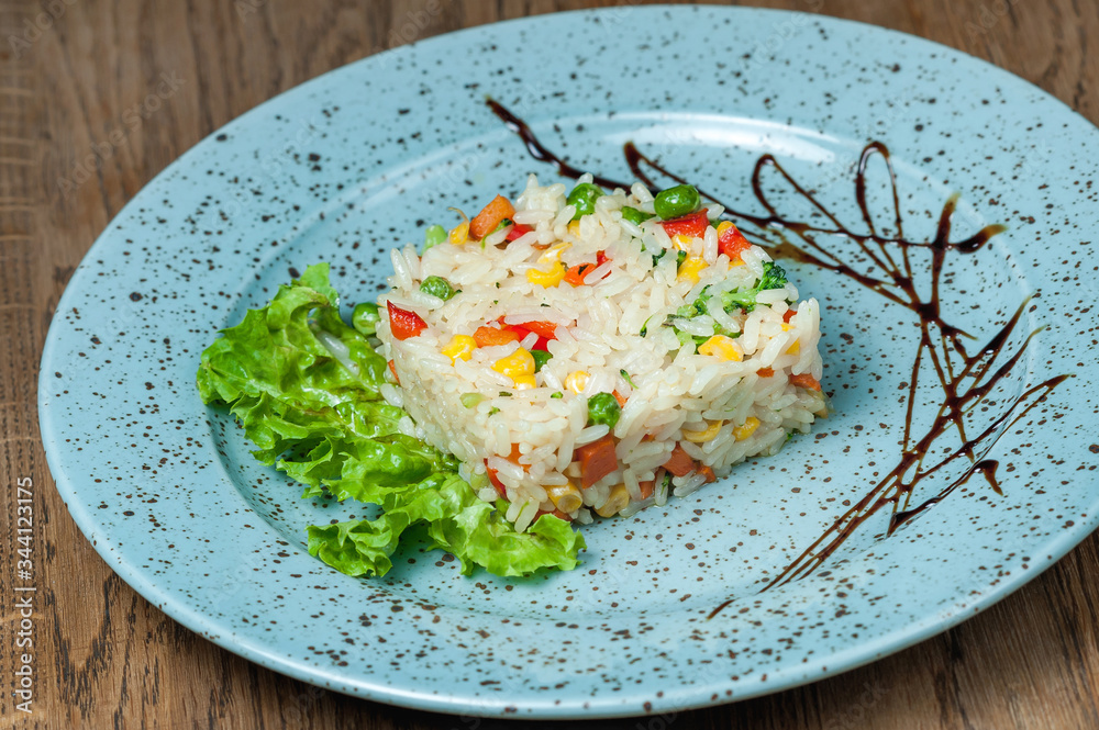 white rice with square vegetables in a blue plate