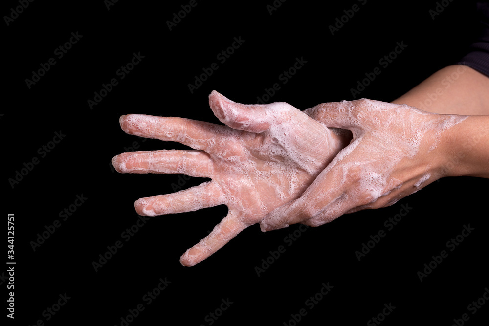 A woman washes her hands with soap to protect against Coronavirus. A woman washes her hands with soap to protect against Coronavirus.