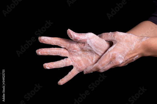 A woman washes her hands with soap to protect against Coronavirus. © bearok