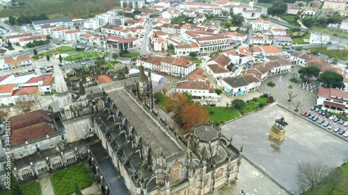 Aerial shot of ancient monastery and surrounding town on rainy day. Batalha,Portugal. photo