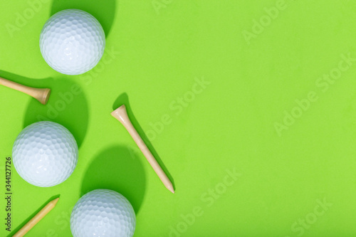 Golf background. Group of golf balls and tee on green background. Top view copy space