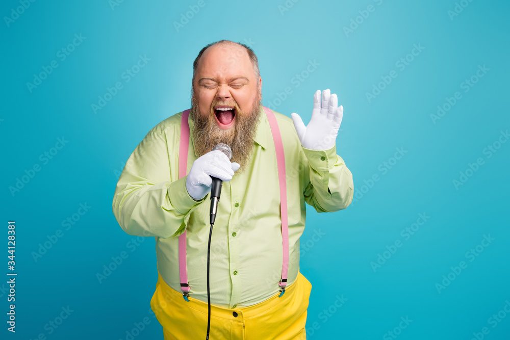 Portrait of his he nice funny funky crazy cheerful cheery glad dreamy addicted bearded man singing karaoke having fun isolated over bright vivid shine vibrant blue green color background Portrait of his he nice funny funky crazy cheerful cheery glad dreamy addicted bearded man singing karaoke having fun isolated over bright vivid shine vibrant blue green color background