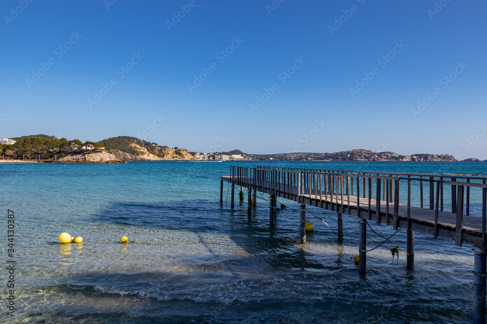 Wooden jetty in Mediterranean Sea at Son Matias, Mallorca during sunset, Spain