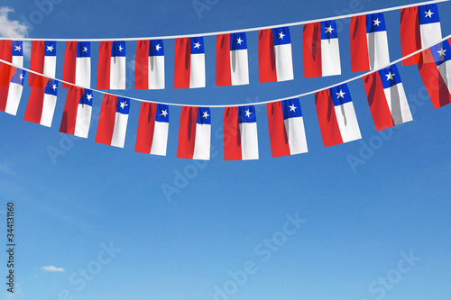 Fototapeta Chile flag festive bunting hanging against a blue sky. 3D Render
