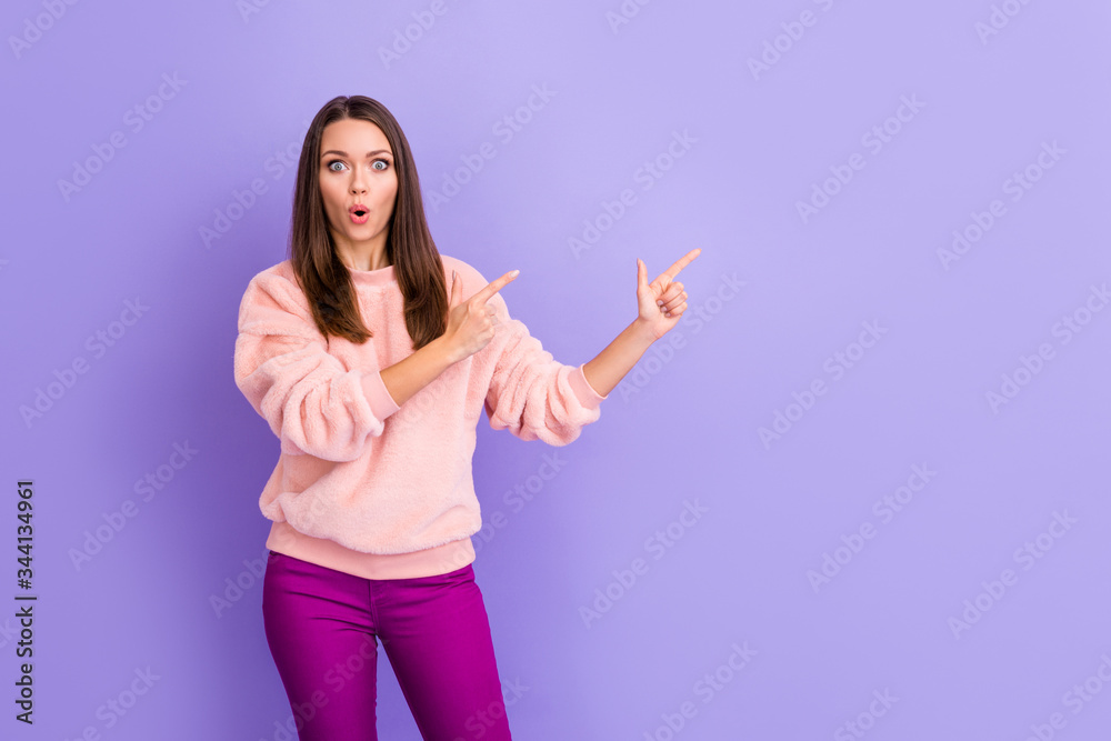 Photo of attractive lady open mouth indicat finger empty space presenting new clothes store low prices wear casual soft fuzzy pullover trousers isolated purple color background
