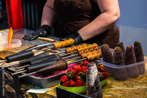 June 8, 2019, Gastrofestival, Yekaterinburg, Russia: Cook prepares hot trdelniki with cinnamon and strawberries. The national street food of the Czech Republic. Editorial photos